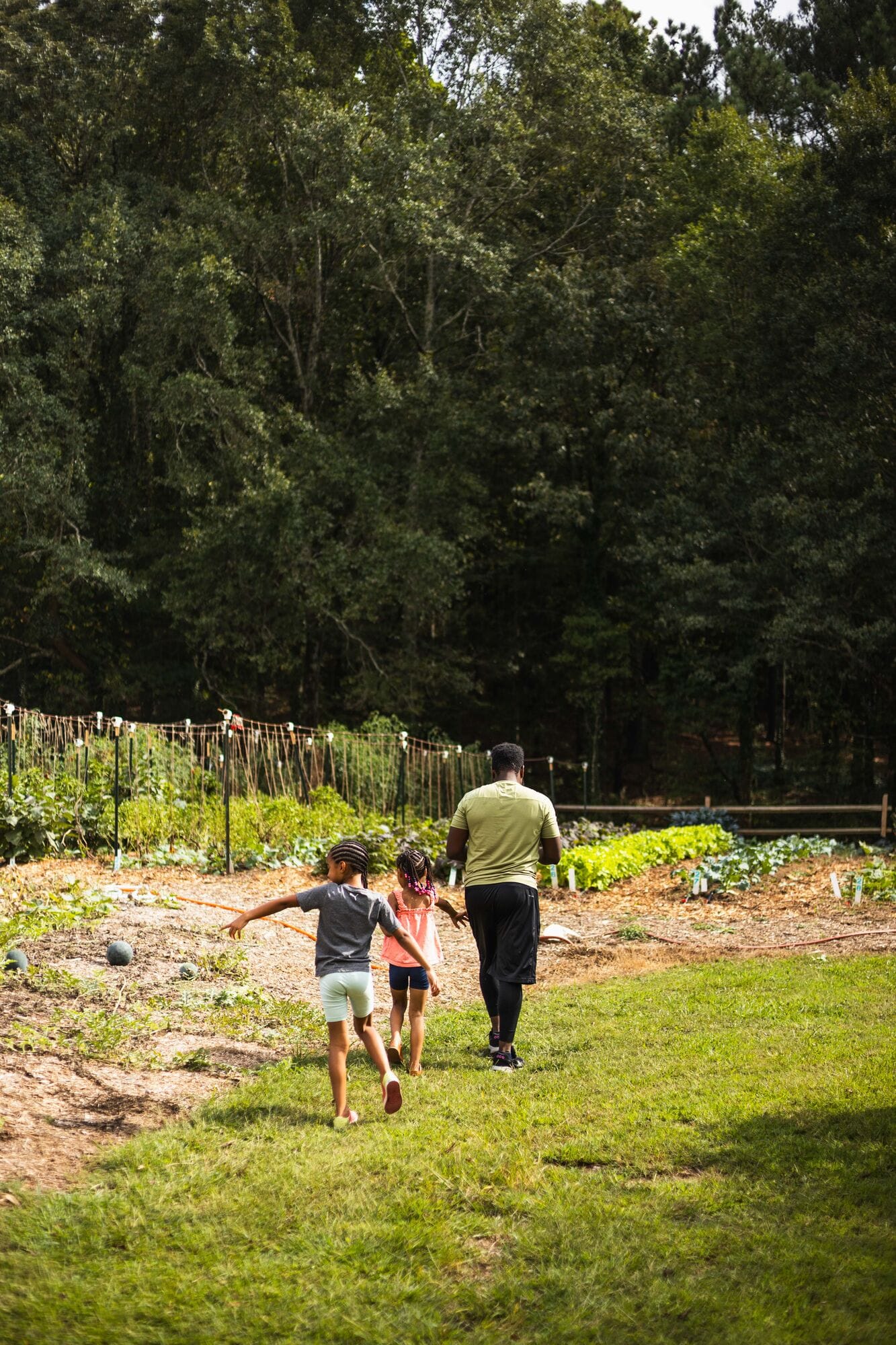 Kids running down the path at the edge of the field